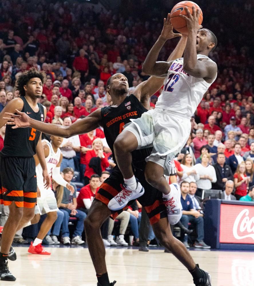 Guard Justin Coleman (12) jumps up to shoot the ball during the game against Oregon State University on Saturday, Jan. 19 at McKale Center. Arizona defeated OSU 82-71. 