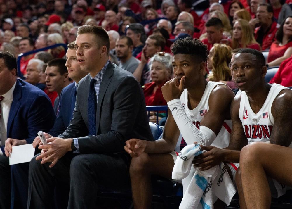 Coaches and players watch the game against Washington on Thursday, Feb. 7 at McKale Center. Arizona lost the game 67-60. 