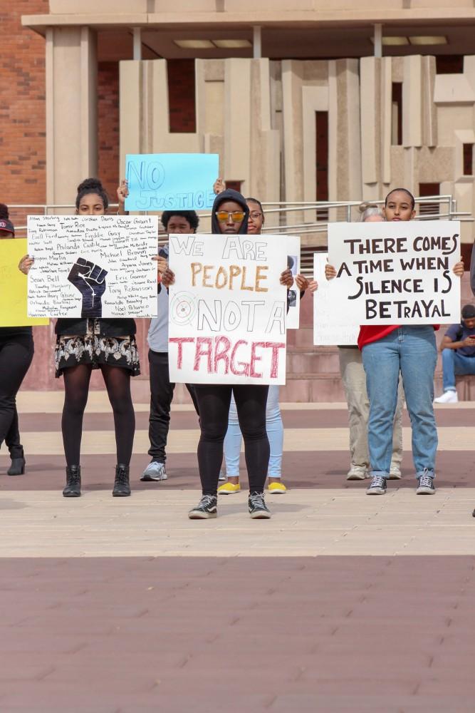 On Tuesday morning, the Black Student Union held their annual silent protest outside of the Admissions Building. Students and other supporters held up signs with hashtags, pictures, illustrations, and quotes to bring awareness and work towards ending police brutality.
