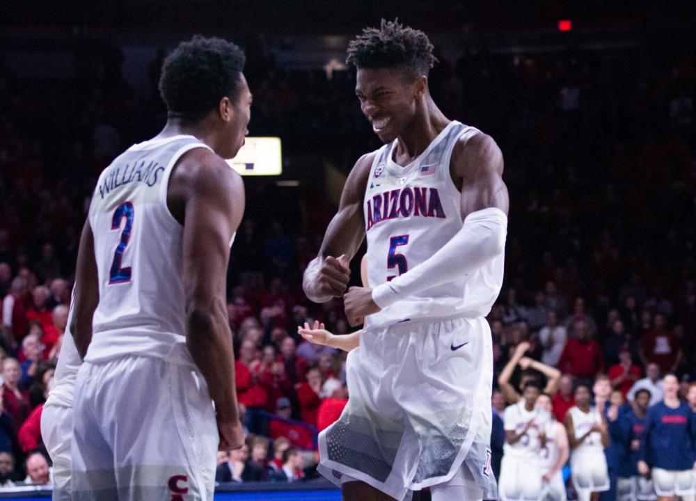 Brandon Williams (2) and Brandon Randolph (5) celebrate Arizona getting a turnover during the game against Stanford on Sunday, Feb. 24 at McKale Center. Arizona defeated Stanford 70-54. 