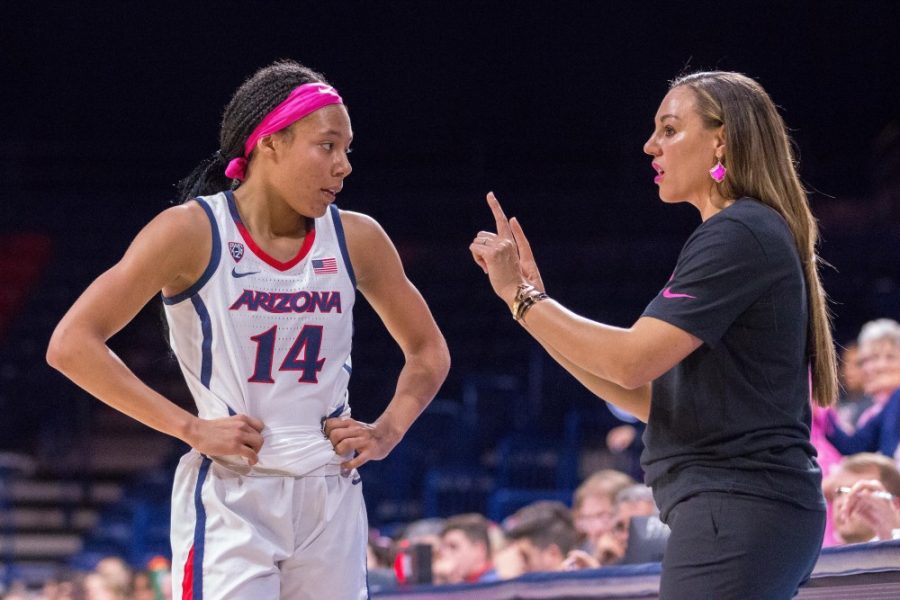 Forward Sam Thomas (14) listens to what head coach Adia Barnes said during a brief timeout in play at the McKale Center. 