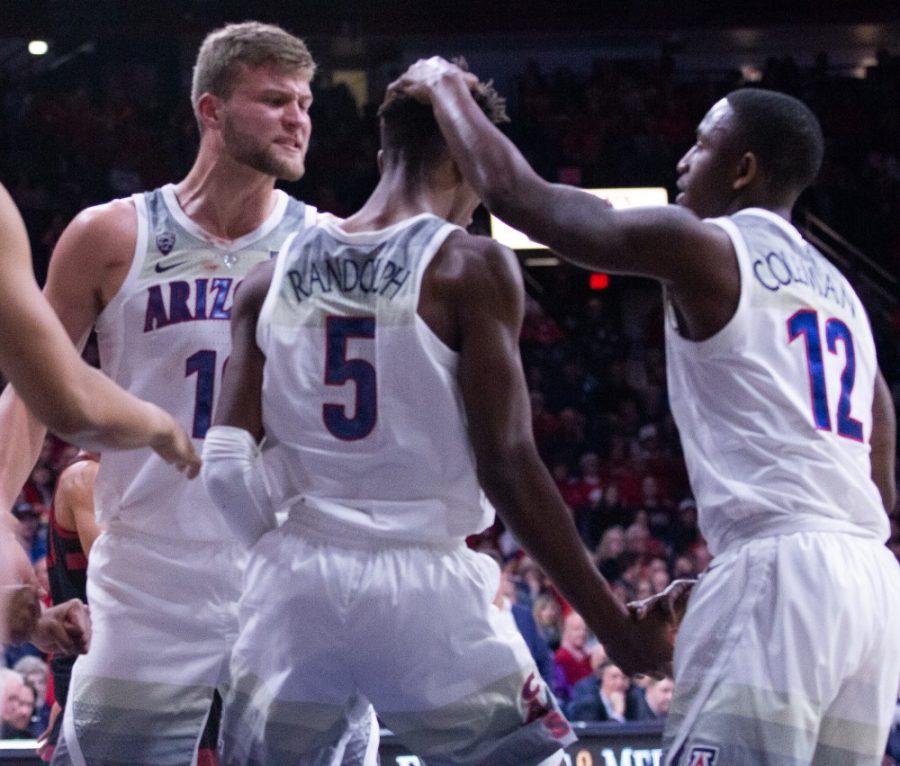 Ryan Luther (10), Brandon Randolph (5) and Justin Coleman (12) celebrate the referee making a call in their favor during the game against Stanford on Sunday, Feb. 24 at McKale Center. Arizona beat Stanford 70-54. 