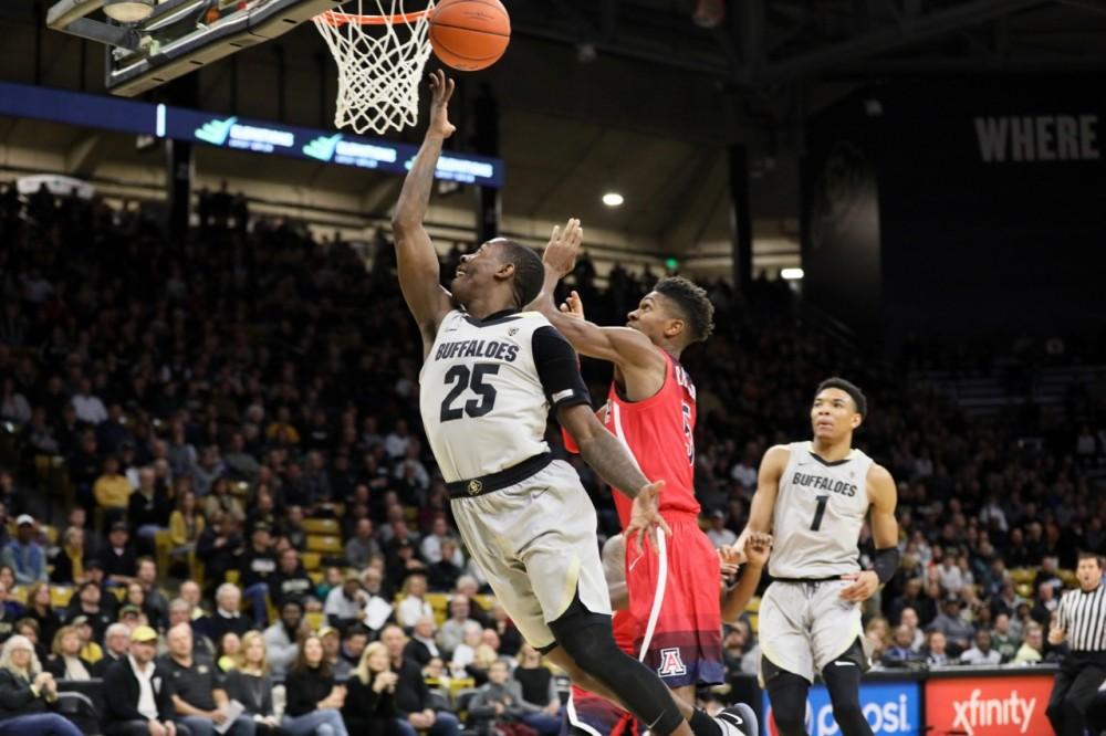 Colorado's McKinley Wright (25) attempt a layup while guarded by Arizona's Brandon Randolph (5) during the Arizona-Colorado game in Boulder, CO on Feb. 17.