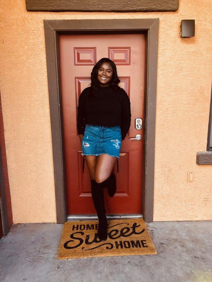 Photo of Brianna Ali, a UA biology major, outside of her student apartment in fall 2018.