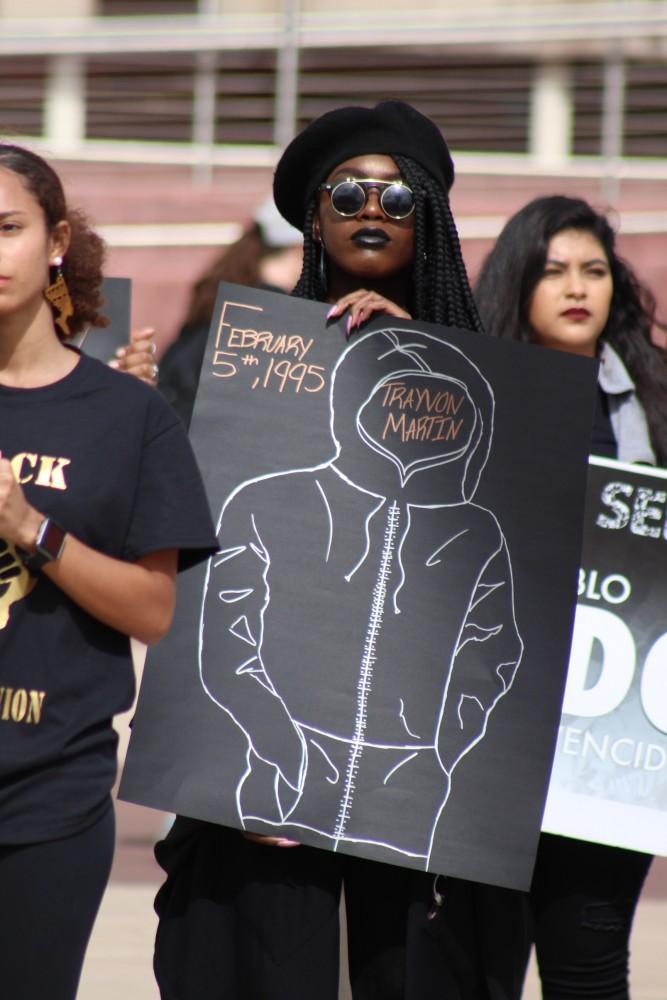 On Tuesday morning, the Black Student Union held their annual silent protest outside of the Admissions Building. Students and other supporters held up signs with hashtags, pictures, illustrations, and quotes to bring awareness and work towards ending police brutality and gun violence.

