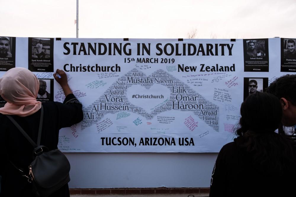 Students write messages to the victims of New Zealand's Christchurch shooting on Mar. 20. The vigil was put on by the Muslim Student Association and the Univeristy Religious Council at the University of Arizona.