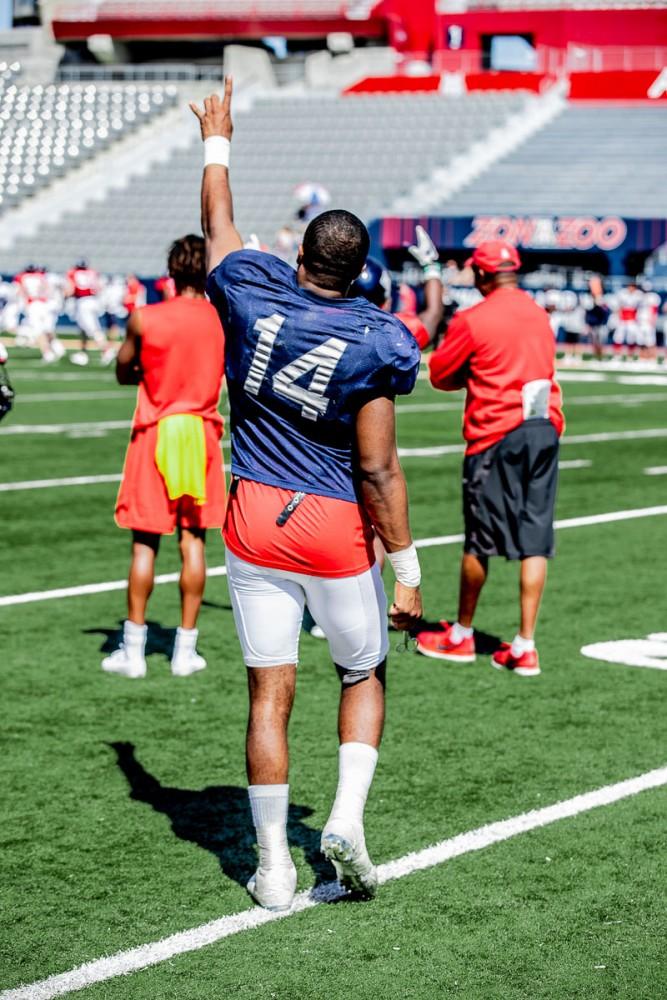 Khalil Tate (14) throws his hand up in the air after completing another day of practice during spring training. 