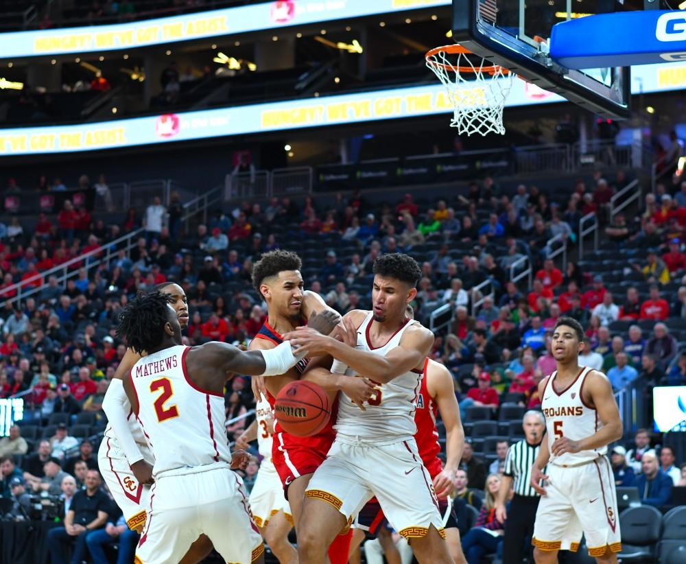 Wildcat Chase Jeter (4) gets doubled team while trying to shoot the ball during the first half of the PAC-12 Tournament game between Arizona and USC. The Wildcats lost to the Trojans 78-65.