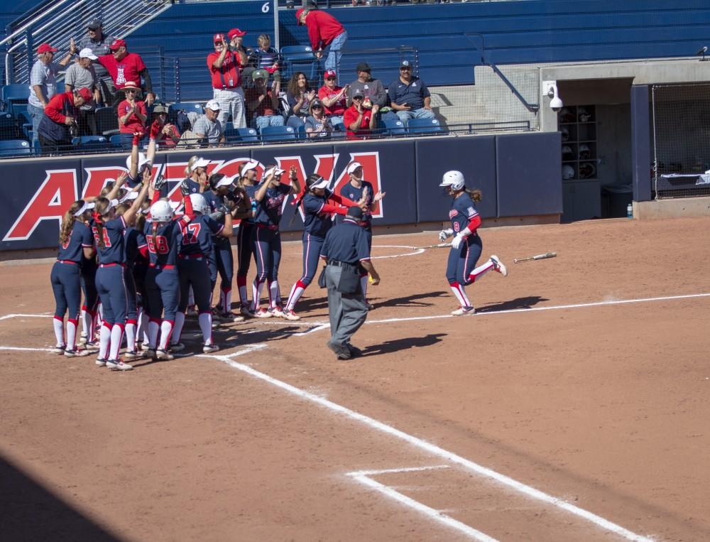 Dejah Mulipola (8) walking home to celebrate her homerun with teammates Saturday March. 16 in Tucson Ariz. In the Hillenbrand Stadium. This was her second home run against Oregon. 