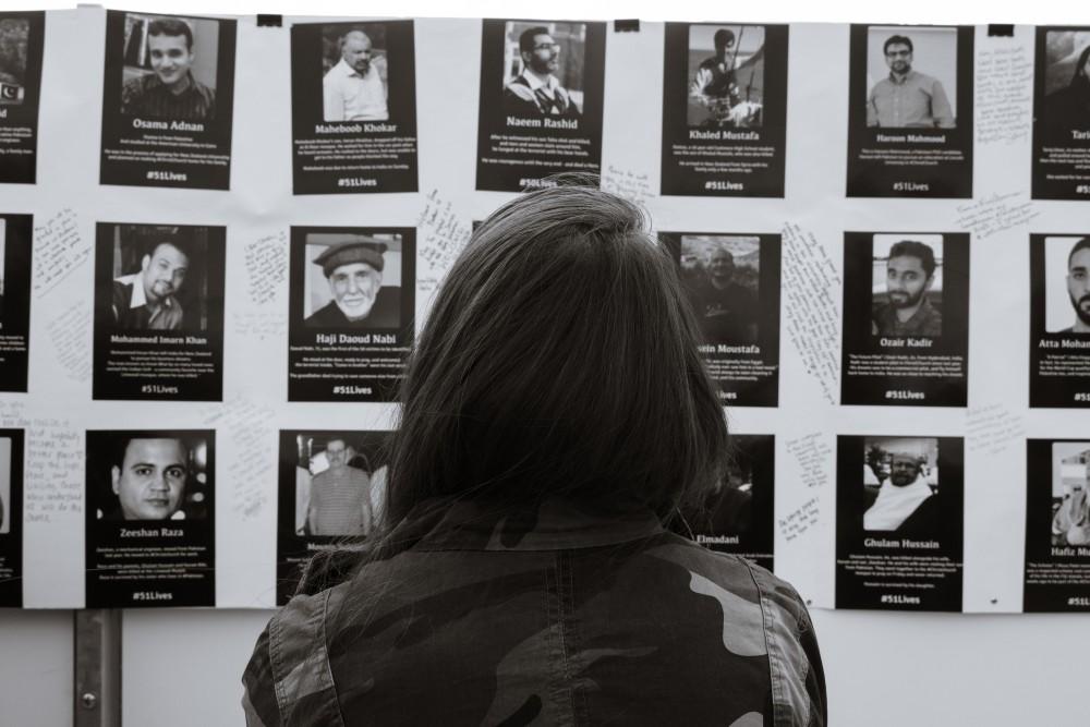 A student stares at the faces of the Christchurch shooting's victims on Mar. 20 in Tucson, Ariz. A total of 51 were killed in the New Zealand shooting on March 15th.