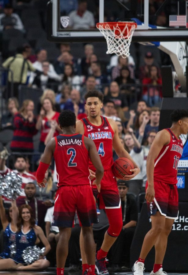 Chase Jeter (4) and Brandon Williams (2) talk before Jeter takes a free throw during the second half of the Arizona-USC PAC-12 Tournament game on March 13, 2019. The Wildcats lost 78-65.