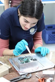 University of Arizona optical Sciences and engineering senior Adriana Mitchell working on CatCam, the camera that would fly on UA’s CatSat spacecraft that was just selected by NASA as part its Cubesat Launch Initiative.