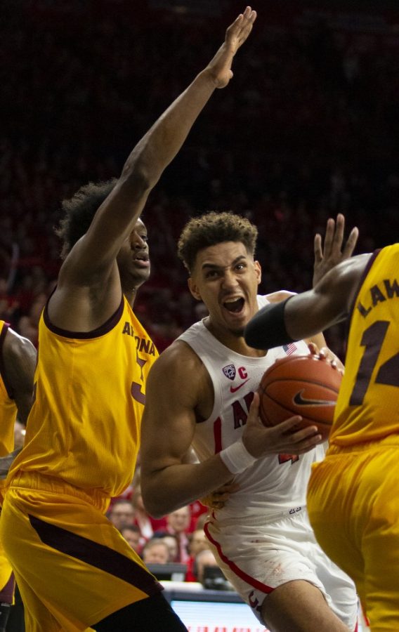 Arizonas Chase Jeter (4) pushes through contact during the Arizona-Arizona State game on Saturday, March 9, 2019 at the McKale Center in Tucson, Ariz.
