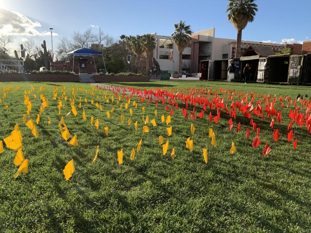 The flags representing the number of people from different groups that were killed. Each flag represents approximately 10,000 people. Just four flags are equivalent to the entire undergraduate population at UA.