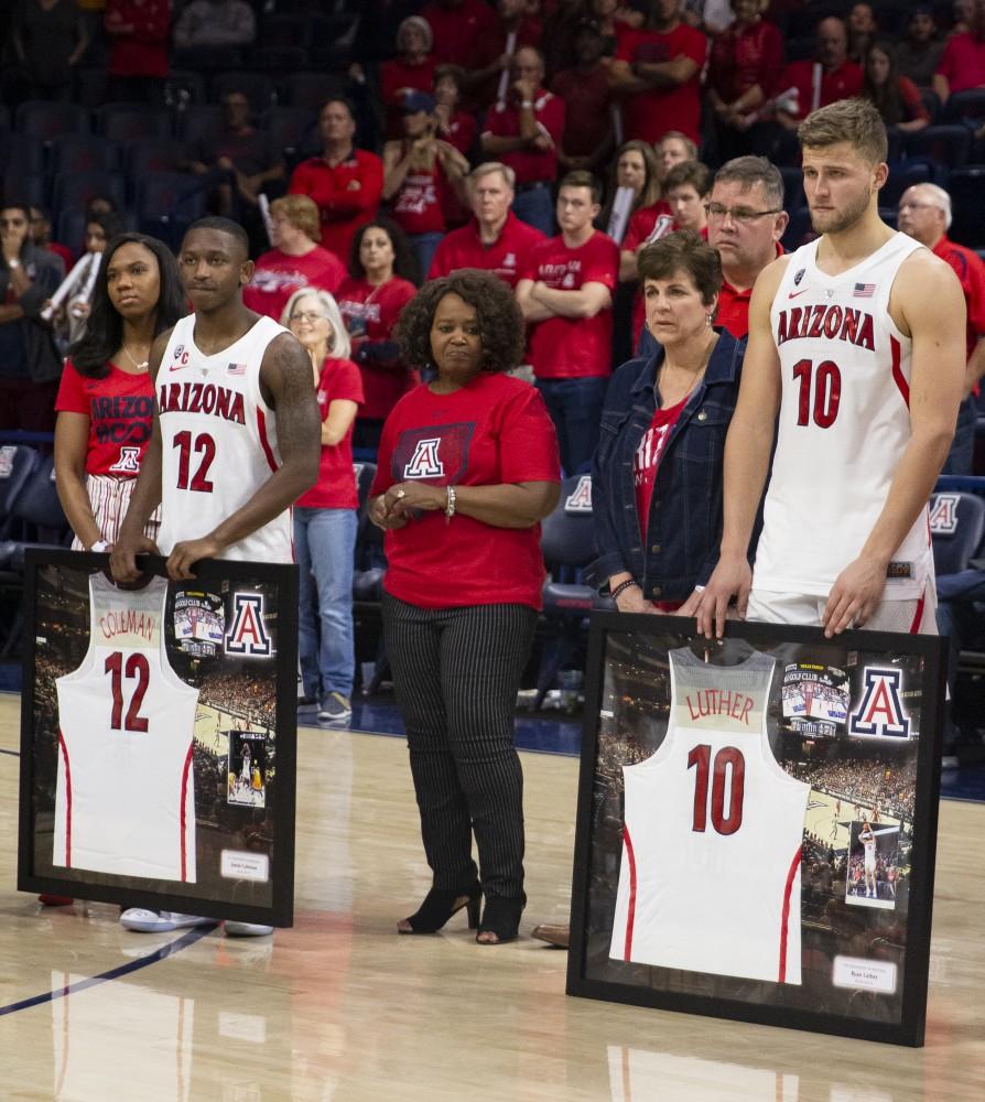 Arizona's Justin Coleman (12) and Ryan Luther (10) stand with their families as they are celebrated on senior night after the Arizona-Arizona State game on Saturday, March 9, 2019 at the McKale Center in Tucson, Ariz.