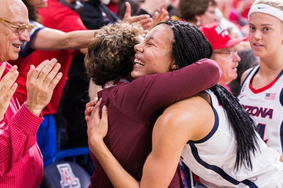Sam Thomas celebrates with a fan after the Wildcats beat Idaho at McKale Center 68-60 to advance to the Elite Eight for the Womens NIT Tournament. [Beau Leone/The Daily Wildcat]