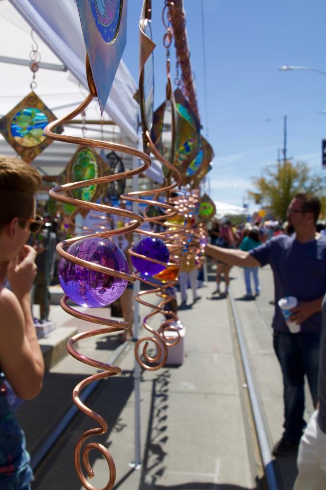 Ornamental decorations hang from a booth on Sunday, March 24, 2019 in Tucson, Ariz. It is estimated that the street fair brings in roughly 300 international artisans.

