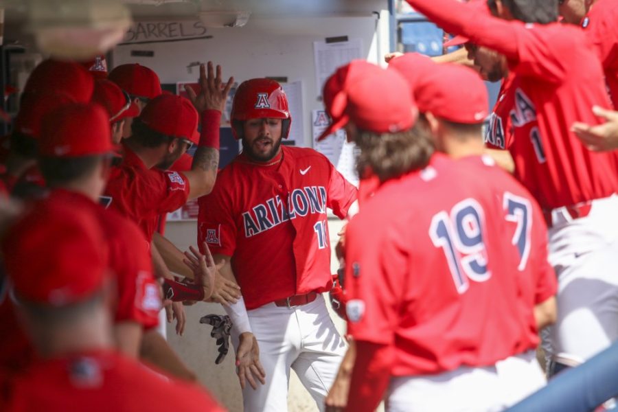 Tucson Ariz.- Catcher, Austin Wells (16) celebrating with his teammates in the dugout on Sunday April 14, 2019 at Hi Corbett Field. Before making a run Austin got the Cats on the board with an RBI double. 