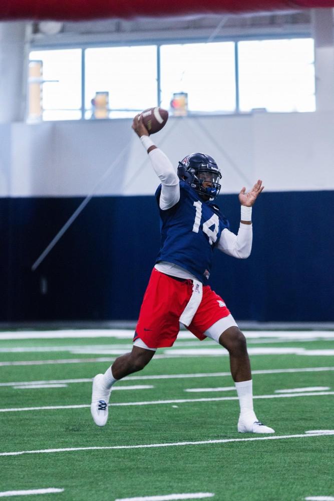 Photo by Beau Leone. Quarterback Khalil Tate (14) gets some passes up during spring practice inside the new Cole and Jeanie Davis Sports Center.