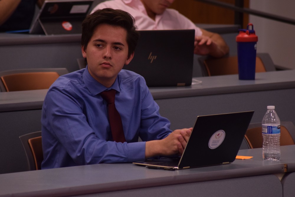 Vincent Jasso watching his fellow debate members during the debate on April 9 covering whether community college tuition should be free. Jasso has been debating for 6 years. 

photo by Chloe Hislop