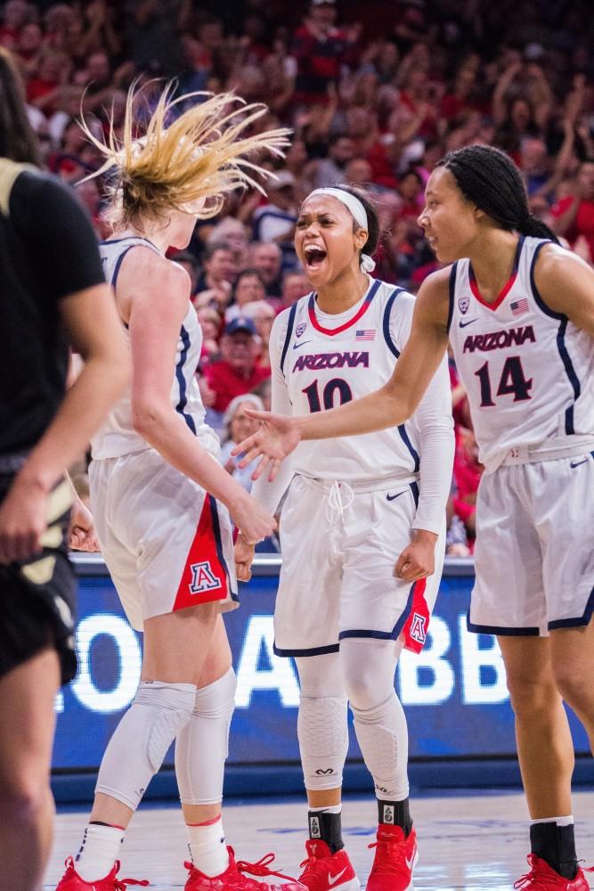 Tee Tee Starks (center) gets hyped with teammates Cate Reese (left) and Sam Thomas (right) after a crucial play in the second half vs Idaho. 