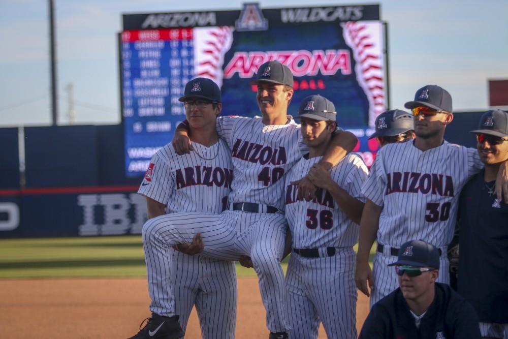 Members of the UA Baseball team smile for a picture after beating Washington 14-2.