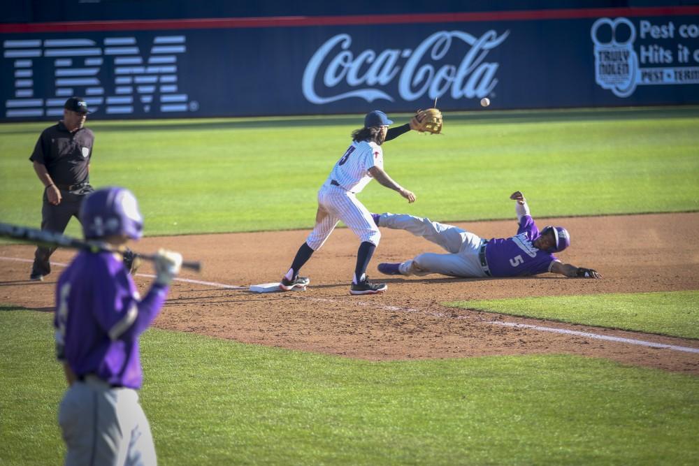 Tucson Ariz.- Infielder, Nick Quintana (13) trying to get an out on third base on Saturday April 6, 2019. The cats defeated the huskies, 14-2. 

