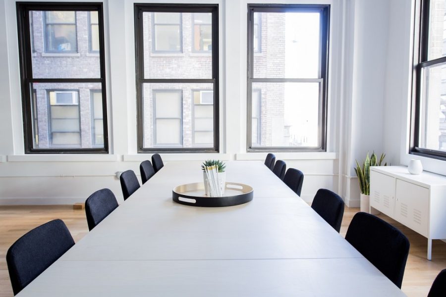 An empty conference room in an office with a table, chairs and big windows, located on 150 W 28th Street, New York, United States. 