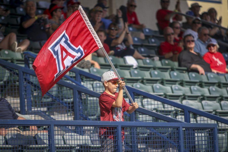 Tucson+Ariz.-+A+little+boy+swinging+an+Arizona+wildcats+flag+on+Sunday+April+14%2C+2019+at+Hi+Corbett+Field.+The+crowd+would+cheer+him+on.+