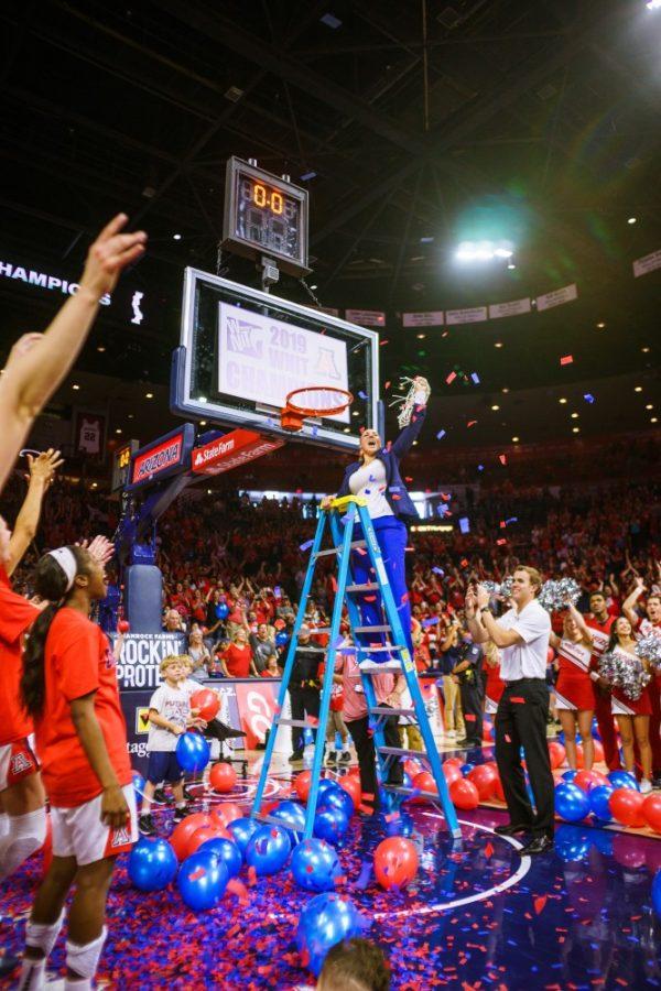 Coach Adia Barnes cuts the championship net after the womens basketball team beat out Northwestern on Apr. 6 in Tucson, Ariz.