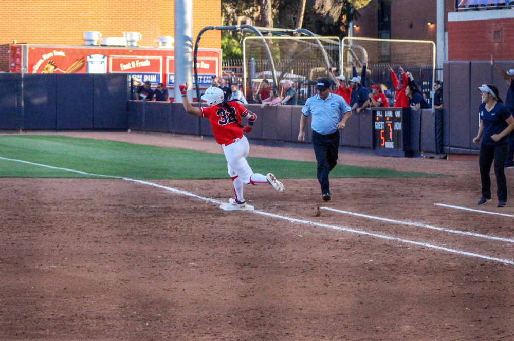 Arizona's Alyssa Palomino-Cardoza pumps her fist after hitting a home run against Ole Miss to help the Wildcats advance to the Women's College World Series.