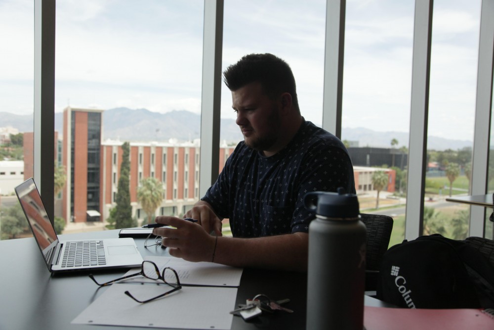 Riley Campbell studies on the eight floor of the Optical Sciences Building.He said he loves the view here.