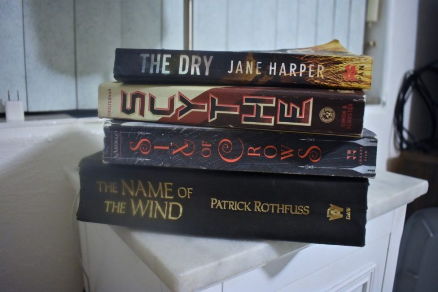 Photo by Jay Walker

Name of the Wind, Six of Crows, Scythe, and The Dry all sit on a nightstand after having been added to the favorite book collection.