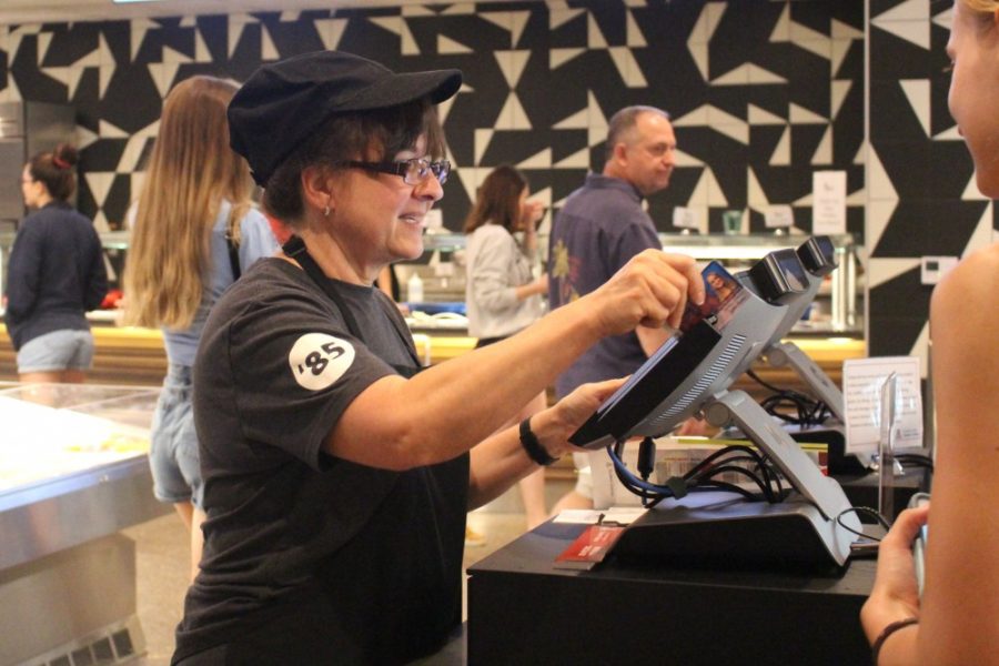 Dining Services Attendant, Dyana McPherson, swipes a catcard for payment. The new Honors Village features a new meal swipe plan for students. 