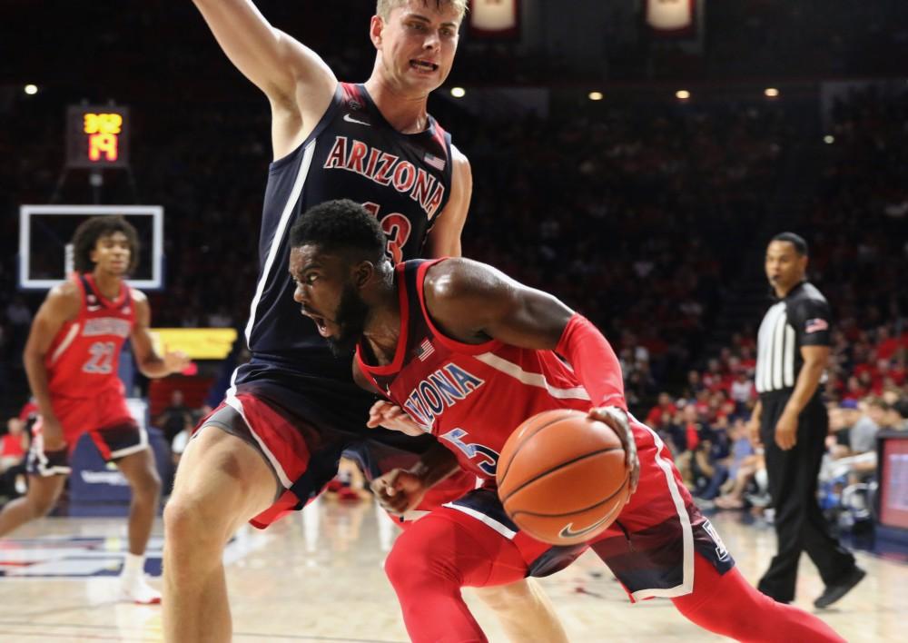Arizona guard Max Hazzard (5) dribbles the ball down the court while being defended by Stone Gettings (13) during the Red-Blue game on September 26. 