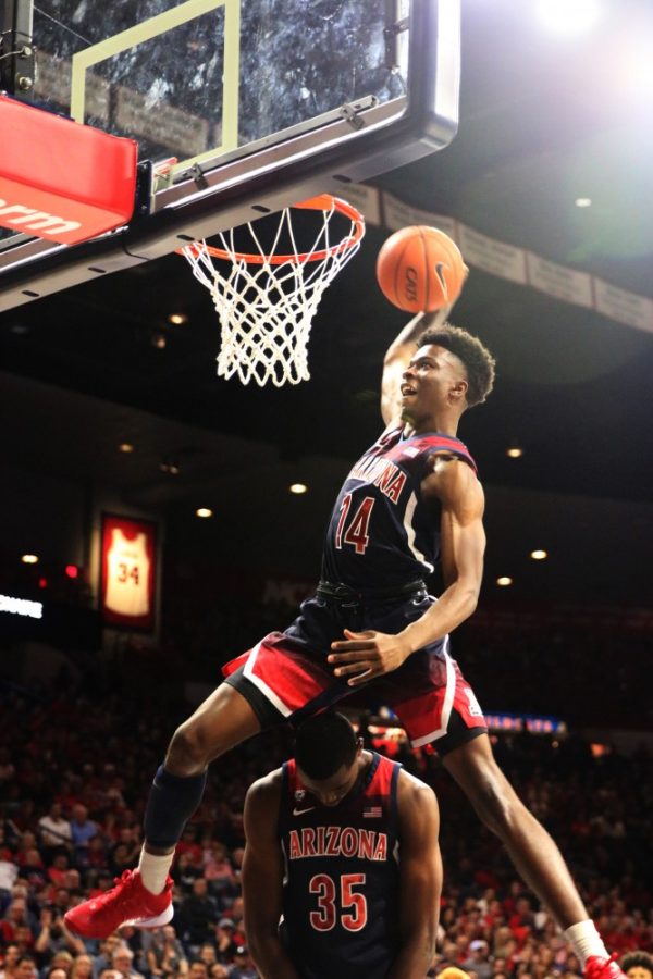 Devonaire+Doutrive+%2814%29+jumps+over+teammate+Christian+Koloko+%2835%29+during+the+dunking+contest.+After+the+dunk+contest%2C+Doutrive+was+called+the+dunk-master.+