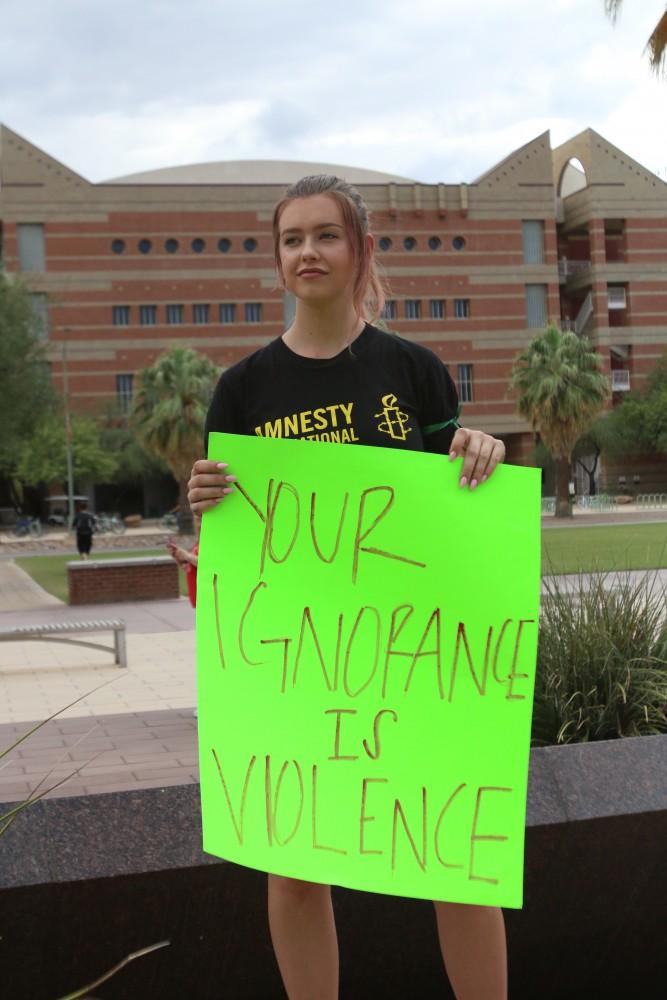 University of Arizona students, faculty and Tucson community members gathered in front of the Administration Building on Friday September 13, to protest the injustice that occurred on Tuesday. Protesters held up signs and wore black to signify their solidarity of the victim. 