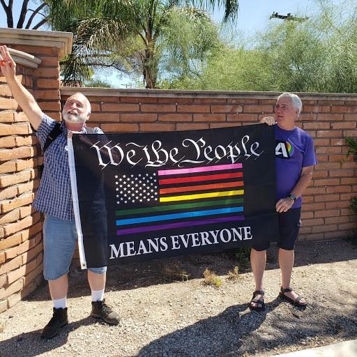 Before the start of the Pride Parade, two Tucson community members showed off their sigh that said We the People means everyone.