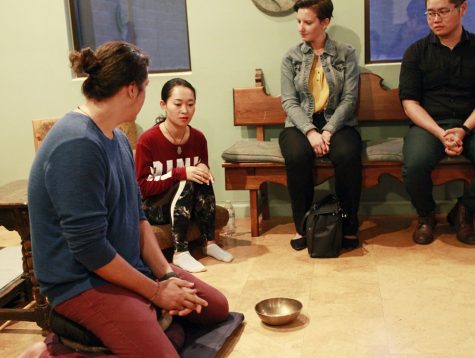 Jeff Schlueter (left), from the Center for Compassion Studies, leads a group in meditation at the University of Arizona on Monday, Sept. 24, 2019.