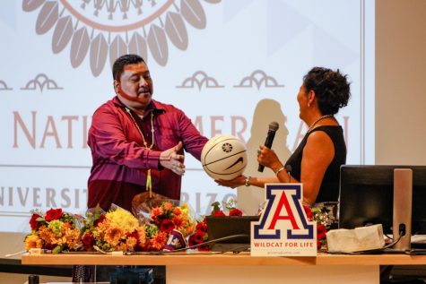 Karen Francis-Begay giving Miguel Flores (Pascua Yaqui) a Sean Miller signed basketball as a thank you for conducting the opening prayer.