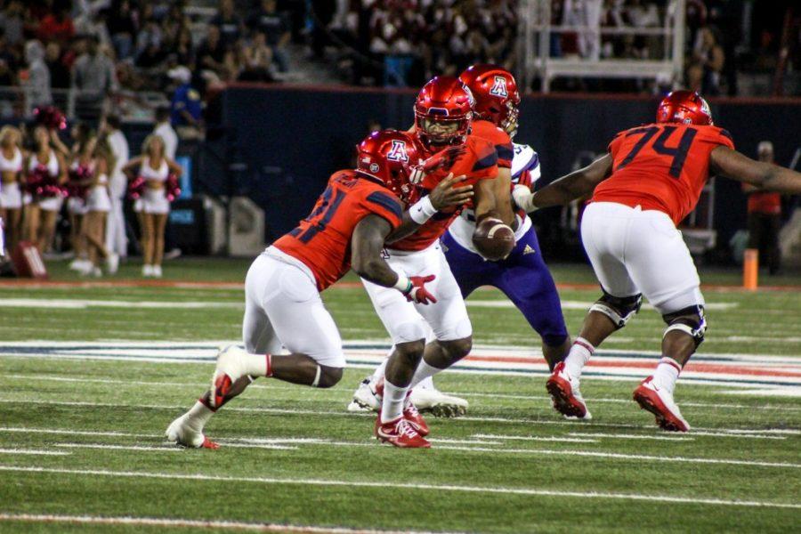 Khalil Tate (14) passing the ball to J.J. Taylor (21) for a run play during the game vs Washington on October 12.