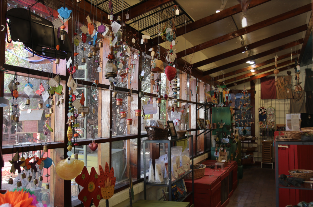 Wind chimes from local organization Ben's Bells hang inside one of the shops in Old Town Artisans. Local handmade items like these are available for visitors to purchase.