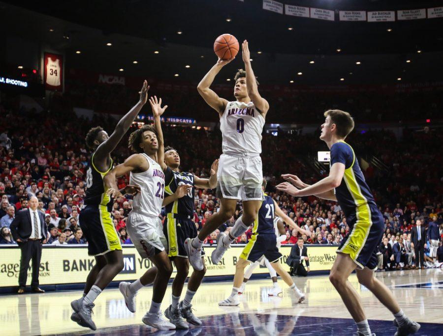 Josh Green (0) jumps and shoots the ball in the first half of the Arizona-Northern Arizona game at McKale Center on Wednesday November 6 in Tucson Ariz.