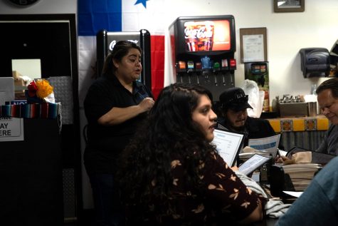 A waitress at Selena's Salvadorian explains their menu before the customers make their final decision on what to eat.