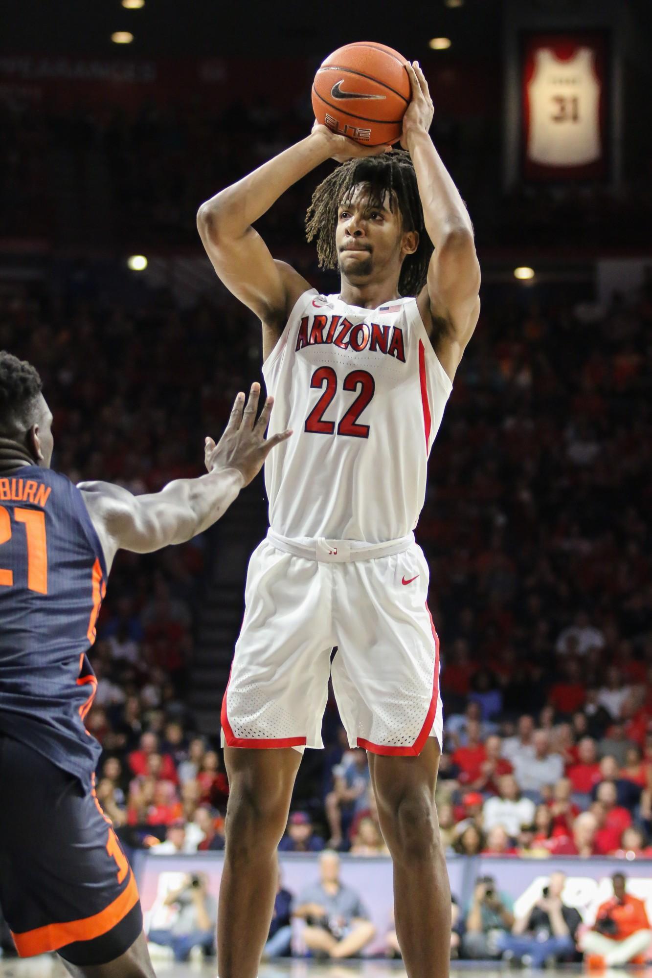 After catching the ball, Wildcat Zeke Nnaji (22) shoots the ball towards the basket and scores a three-pointer for Arizona. 