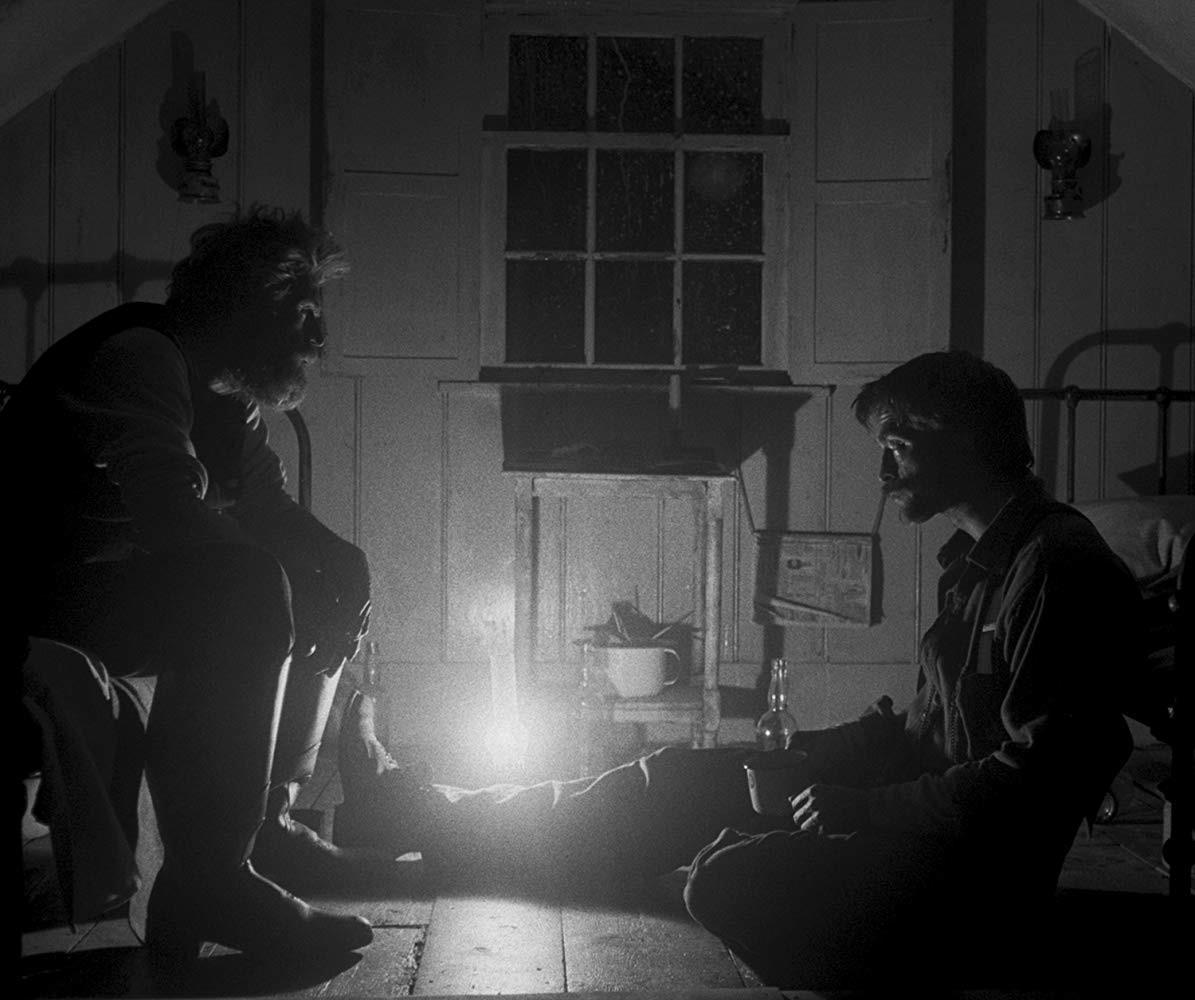 Ephraim Winslow (Robert Pattinson) and Thomas Wake (Willem Dafoe) are two lighthouse keepers in the hypnotic black-and-white period film "The Lighthouse" (2019).