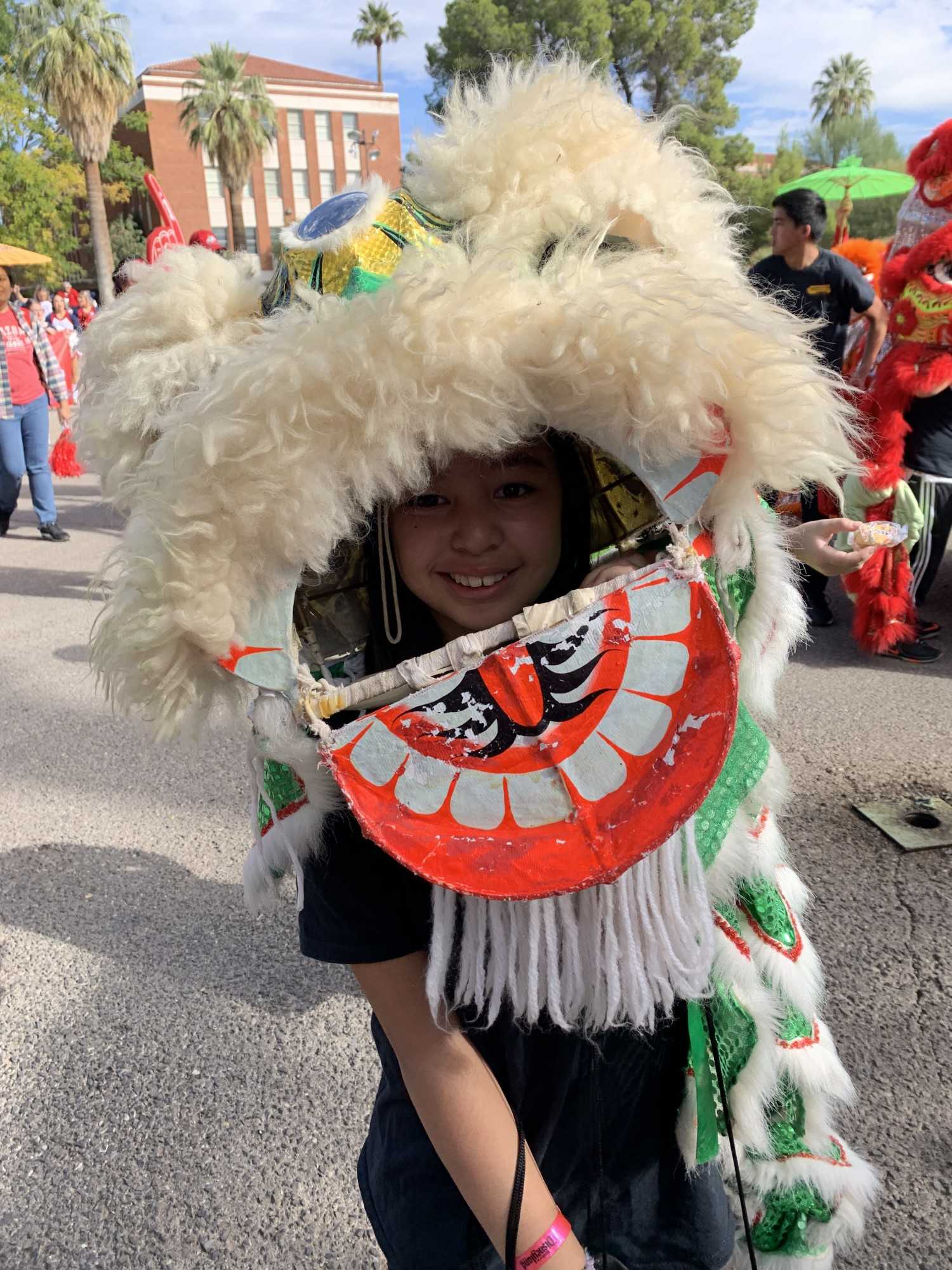 A child marches with the University of Arizona Department of East Asian Studies in the 2019 Homecoming Parade on Nov. 2.