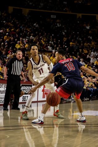 Wildcat Jemarl Baker Jr. (10) tries to block an Sun Devil from passing during the first half of the Arizona- Arizona State game at the Desert Financial Arena in Tempe, Ariz.
