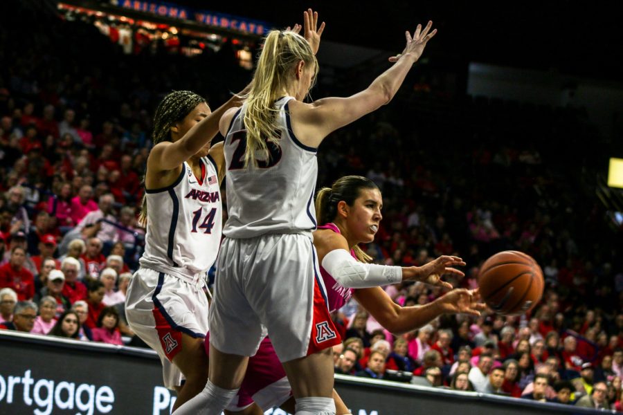 Cate+Reese+%2825%29+and+Sam+Thomas+%2814%29+blocking+during+the+game+vs+Washington+on+February+14.+The+Wildcats+won+the+night+with+a+score+of+64-53.