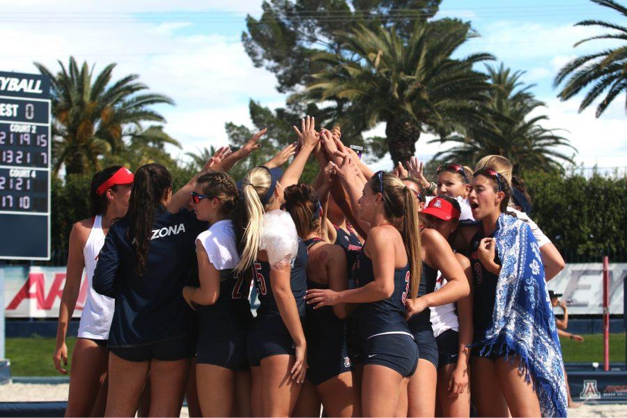 The Arizona beach volleyball team huddles to celebrate their win. Arizona swept Stephen F. Austin State University, 5-0. 
